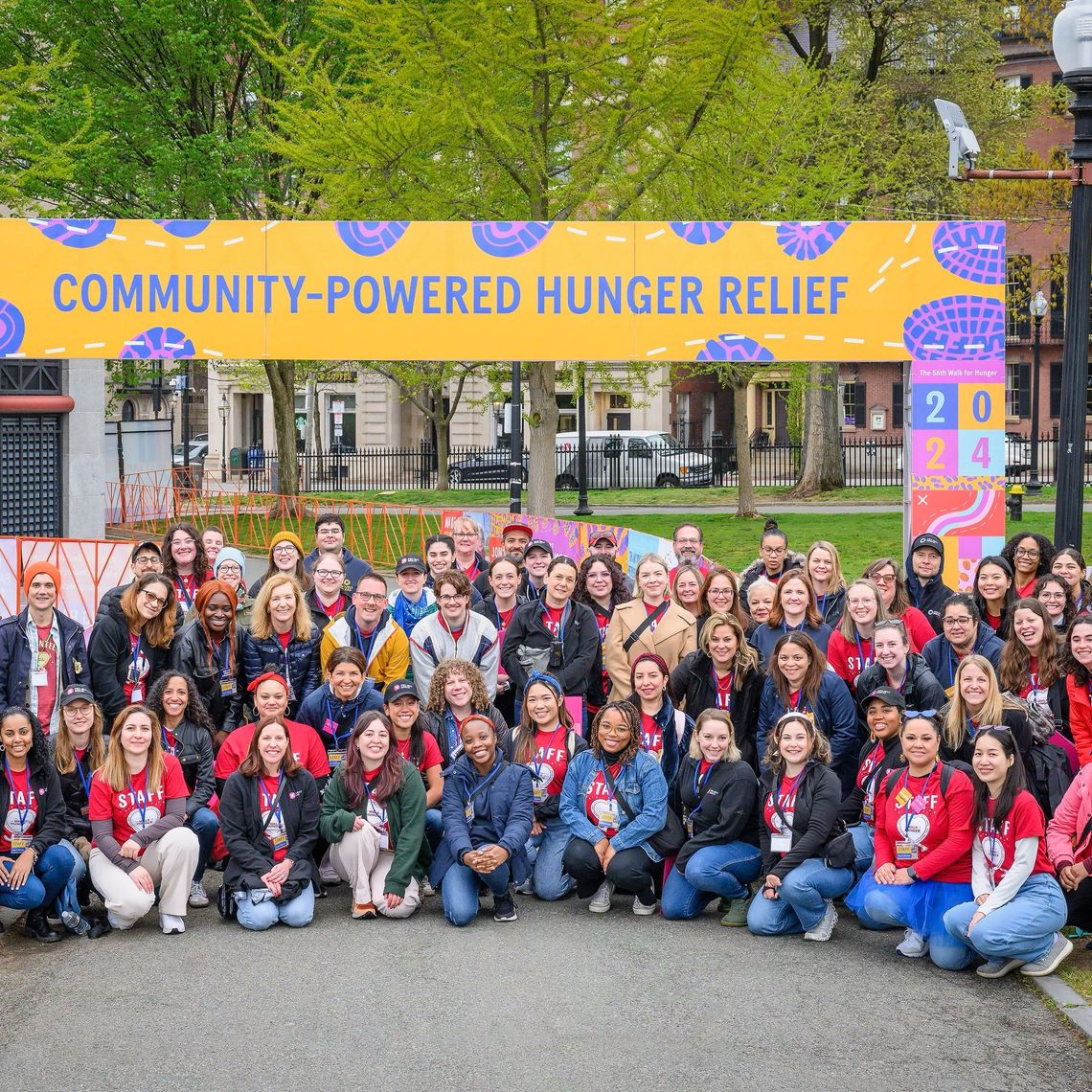 Project Bread staff smiling in front of the starting line banner at the Walk for Hunger