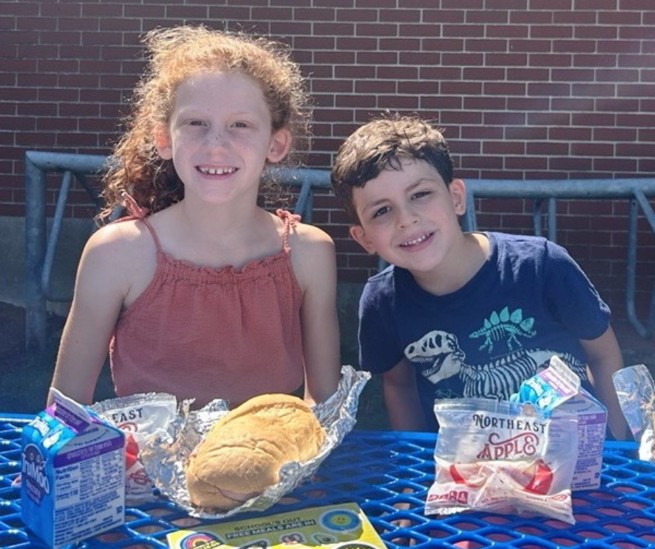 Kids enjoy a free Summer Eats meal at Phelps Elementary School.