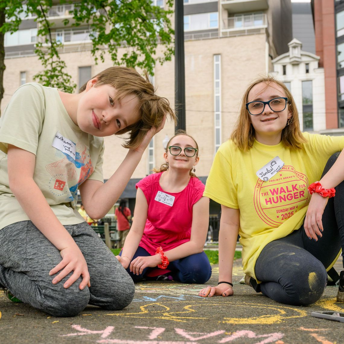 Youth walkers at the walk for hunger drawing on the sidewalk with chalk