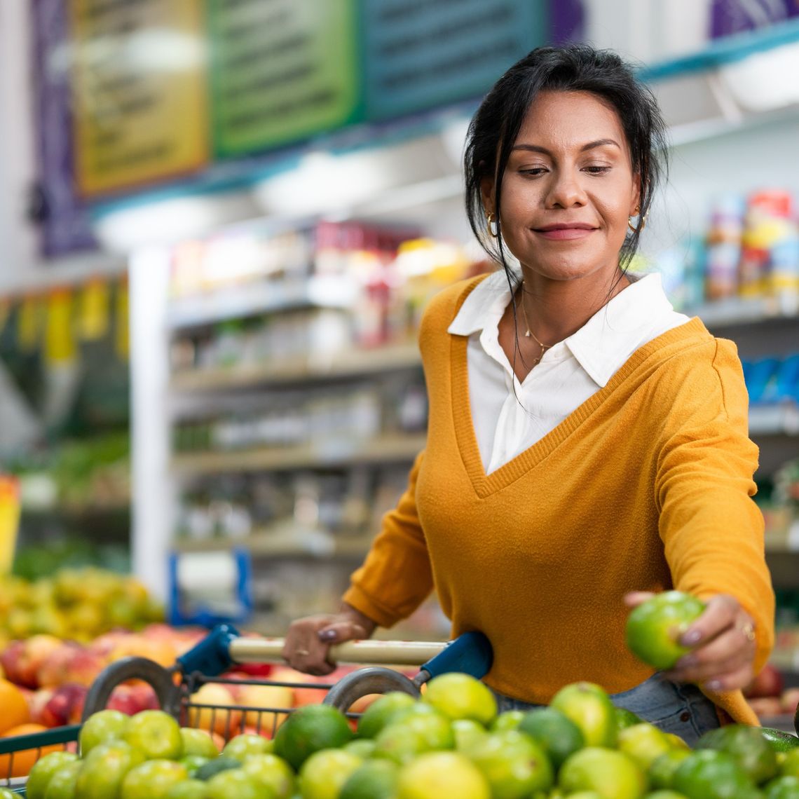 woman picking up a lime