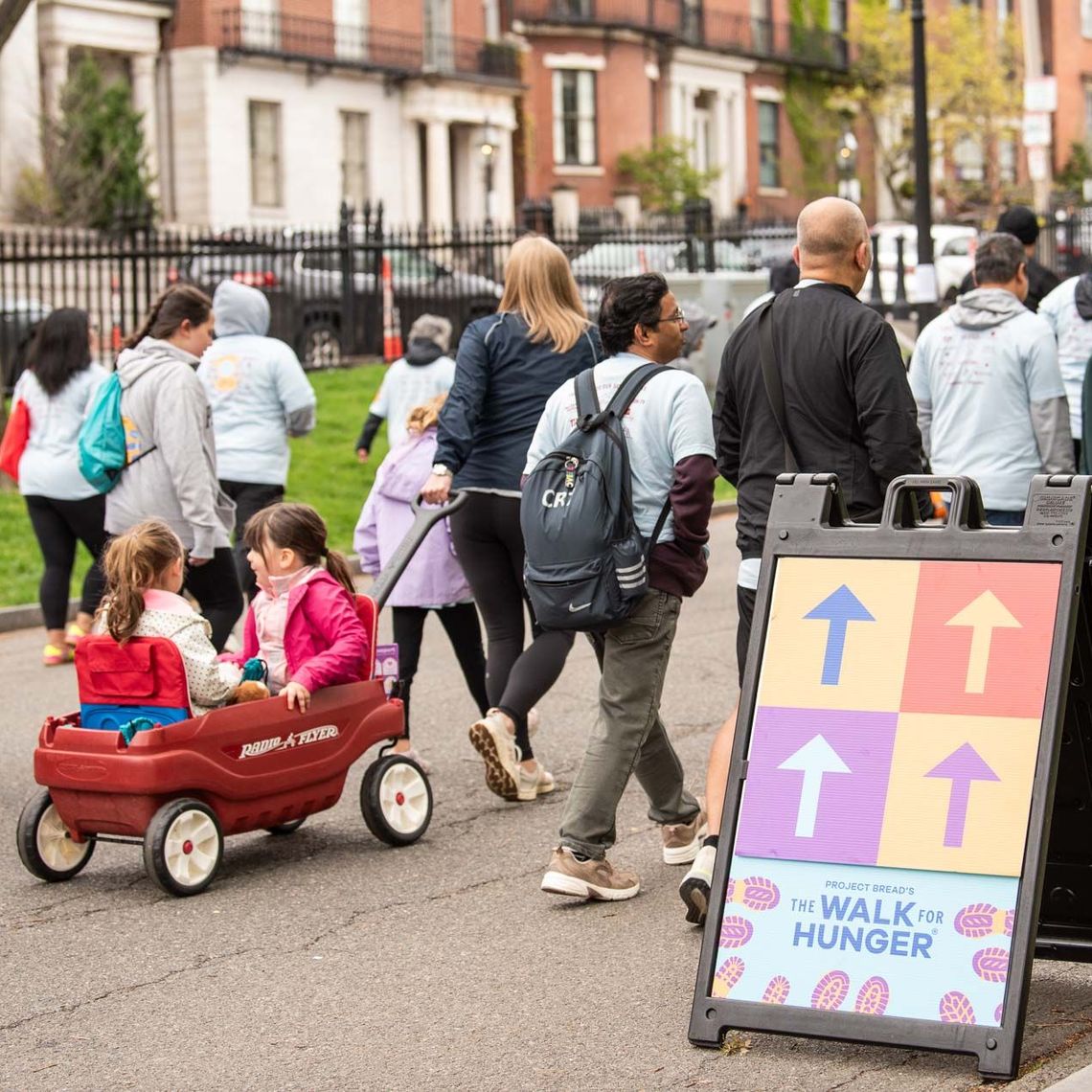 two girls being pulled in a wagon at The Walk for Hunger