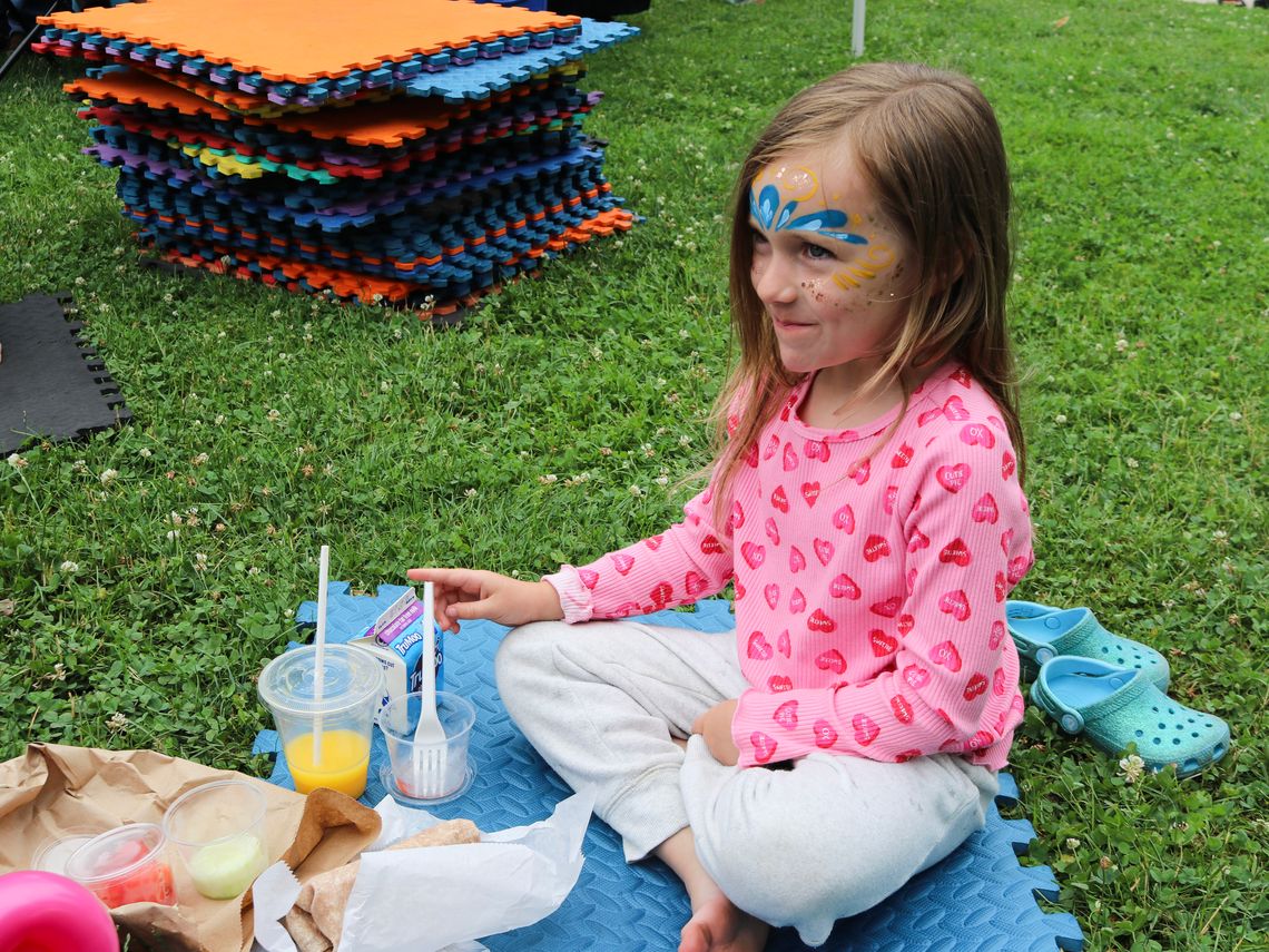 A child enjoys their meal at the Waltham Summer Eats Kickoff.