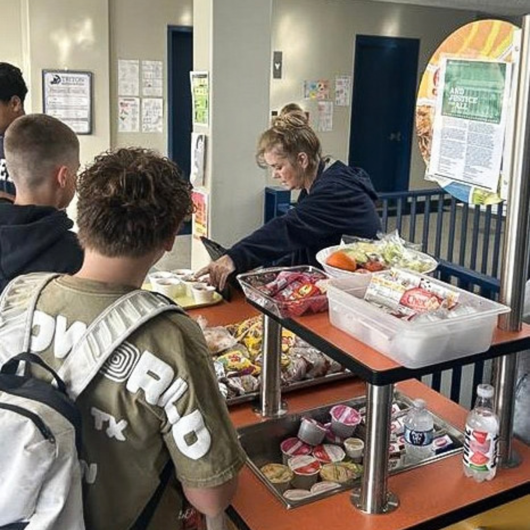 Students line up to get their breakfast.